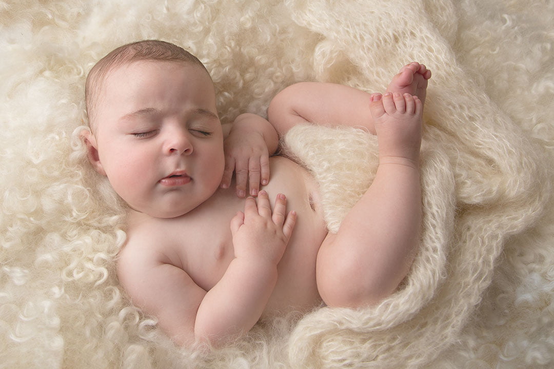 baby boy in cream curls taken by Newborn Photography Bradford 