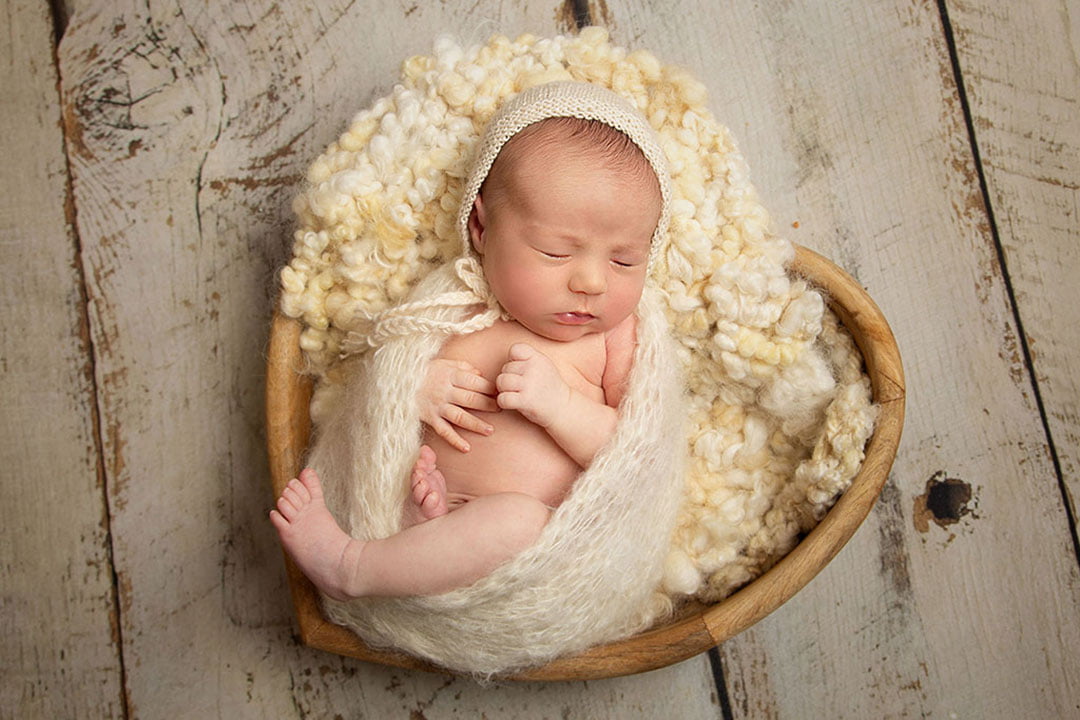baby boy snuggled in heart bowl Newborn Photographer Bradford 