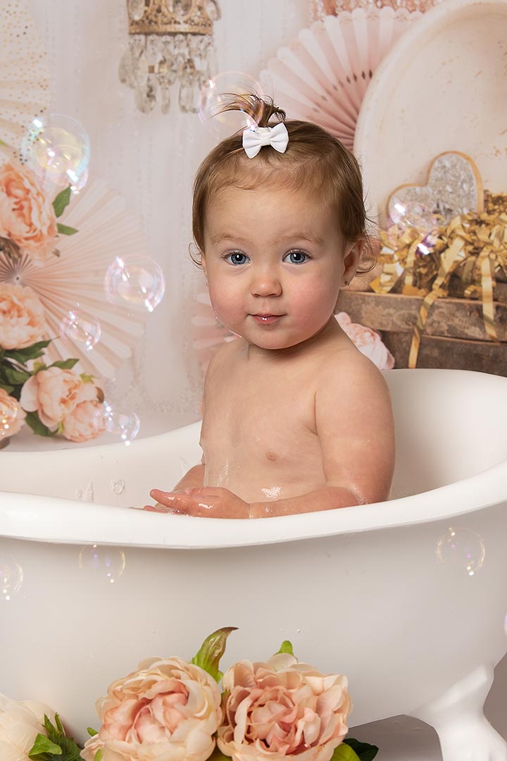 baby in bath with hair clip 